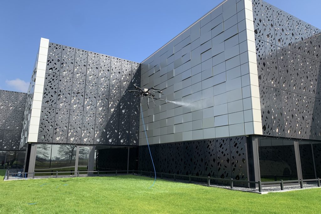 Bandi Drones setup to clean metal facade in an urban area in lagos Nigeria